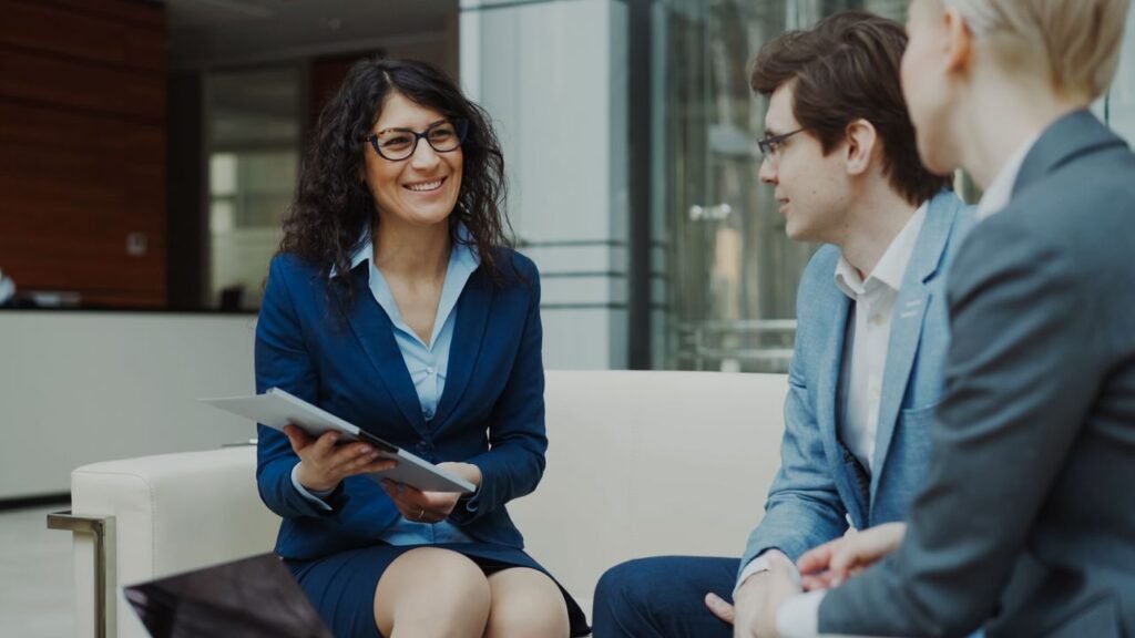 Professionals discussing business strategy in a corporate office setting.